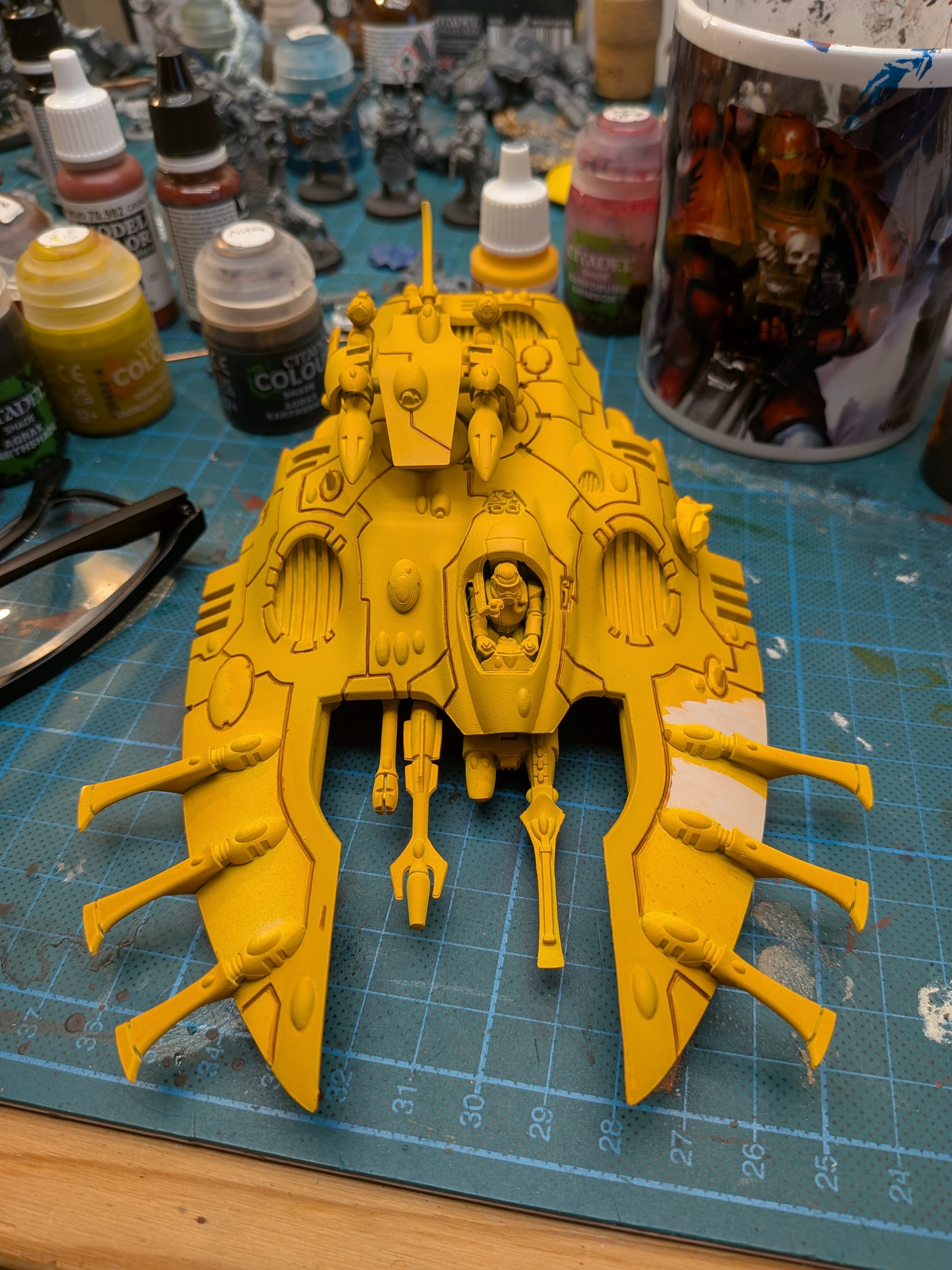 a photo of a Warhammer model; an Aeldari Wave Serpent, a kind of futuristic almost insect-like attack vehicle.