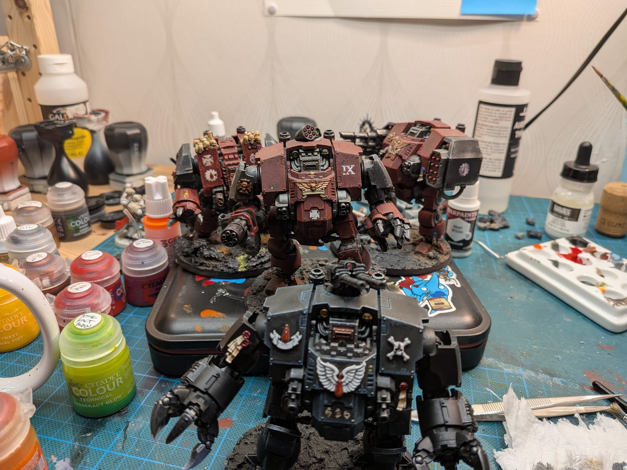 Four Dreadnoughts posing. Three are red, one is black.